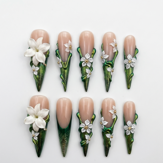 Premium stiletto-shaped press-on nails featuring high-relief 3D botanical art and metallic ivy green finishes, perfect for a statement manicure.