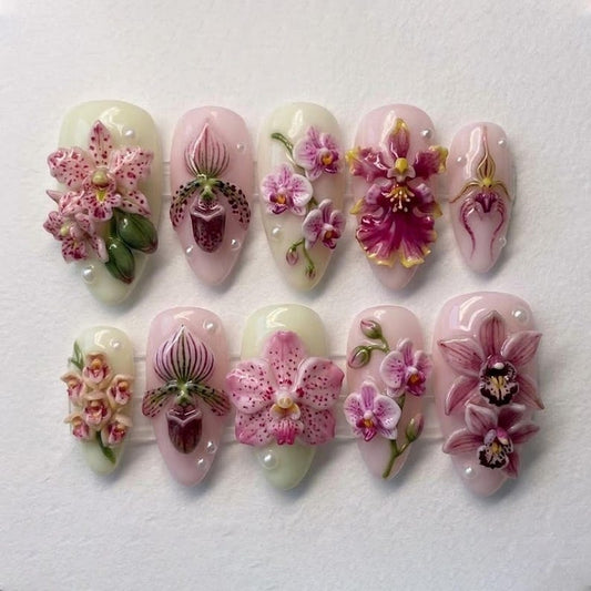 Decorative nail art with pink flowers on a white background