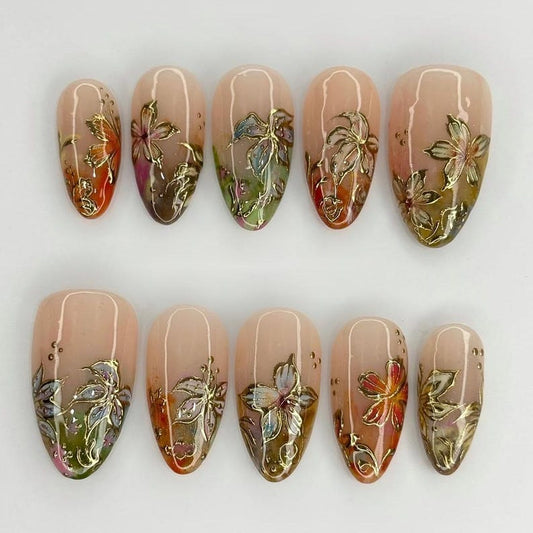 Sophisticated floral gel manicure set with intricate gold-embossed details and earthy tones