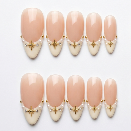 High-quality handmade press-on nails with white French tips, delicate gold stars, and pearls for a sophisticated nail look.