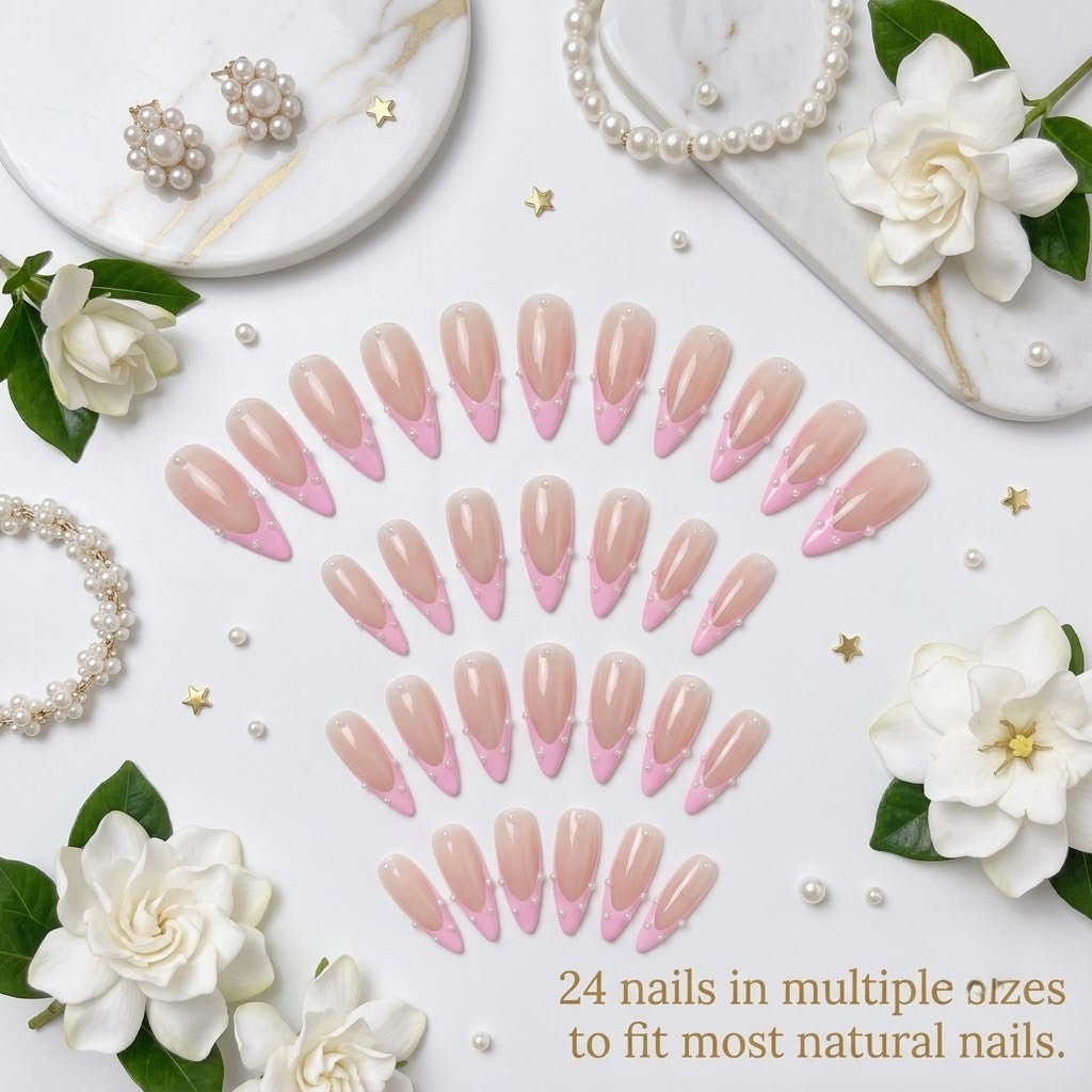 A premium 24-piece luxury press-on nail set featuring sharp stiletto tips with a sheer nude base, pastel pink French tips, and delicate micro-pearl borders, arranged neatly in rows over a white background with white gardenia flowers, pearl jewelry, and a text banner reading '24 nails in multiple sizes to fit most natural nails.