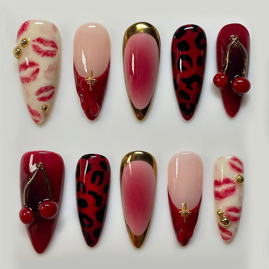 Luxury red French tip press on nails with 3D cherry design, metallic accents, ombré finish, and leopard print. Reusable long almond fake nails with adhesive tabs from JRNAIL.