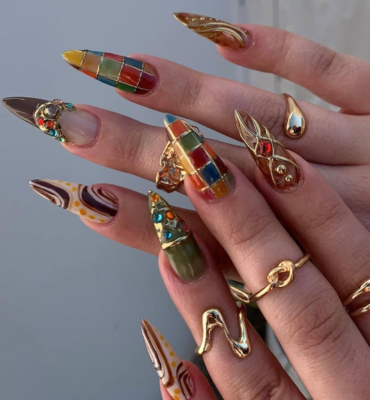 Elegant long stiletto gel nails featuring stained glass designs and luxury rhinestones.