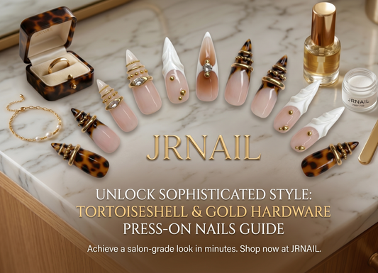 JRNAIL luxury tortoiseshell and gold hardware stiletto press-on nails displayed on a marble surface with styling accessories, featuring the blog title 'Unlock Sophisticated Style: Tortoiseshell & Gold Hardware Press-On Nails Guide'