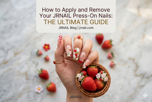 JRNAIL blog post cover titled How to Apply and Remove Your JRNAIL Press-On Nails: The Ultimate Guide, featuring a hand with luxury strawberry-themed press-on nails holding a small basket of fresh strawberries.