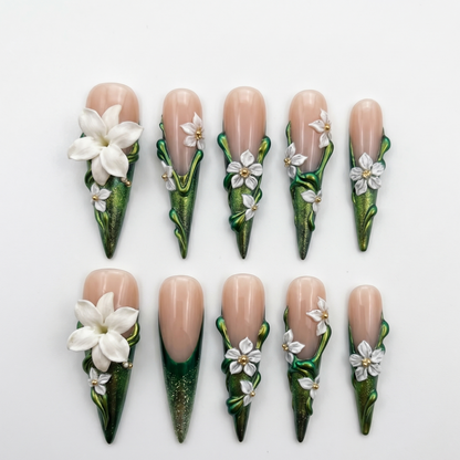 Premium stiletto-shaped press-on nails featuring high-relief 3D botanical art and metallic ivy green finishes, perfect for a statement manicure.