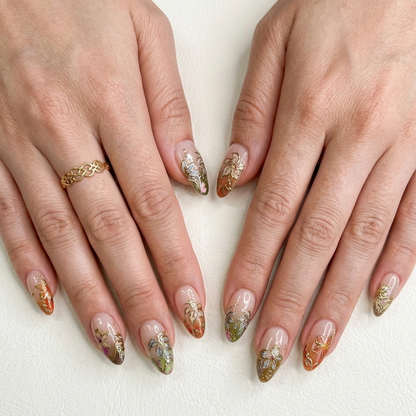 Handmade 3D gold-embossed botanical press-on nails in a luxurious stiletto shape by JRNAIL.