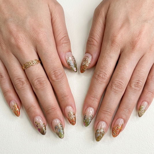 Handmade 3D gold-embossed botanical press-on nails in a luxurious stiletto shape by JRNAIL.