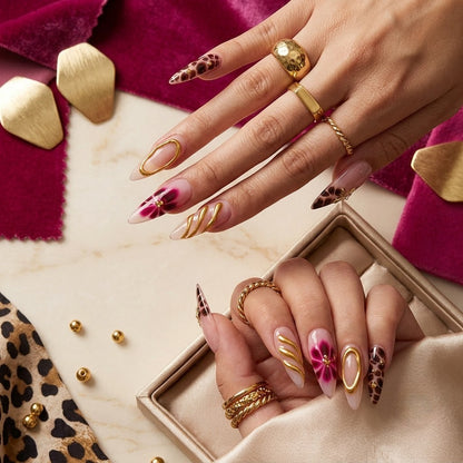JRNAIL high-fashion stiletto fake nails showcasing a high-gloss salon gel finish with fierce leopard accents and glamorous 3D gold swirls, perfect for an editorial DIY home manicure.