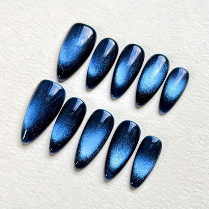 Elegant almond-shaped press-on nails in a deep midnight blue shade, showcasing high-quality magnetic cat eye nail art by JRNAIL.