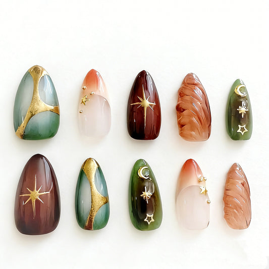 Celestial boho almond press on nails with gold moon, star, sunburst accents, marble, ombré, and 3D texture designs