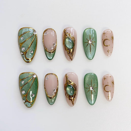 Luxury art deco press on nails with gold filigree, nude pink base, and emerald green gem details
