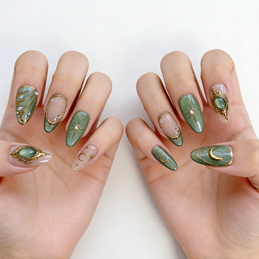 Celestial emerald green gold press on nails with moon star motifs, cat-eye shimmer, and crystal accents