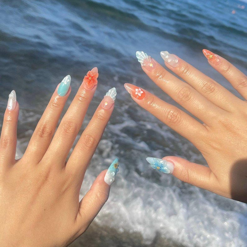 Tropical beach fake nails with 3D seashells, jellyfish designs, and hand-painted hibiscus flowers