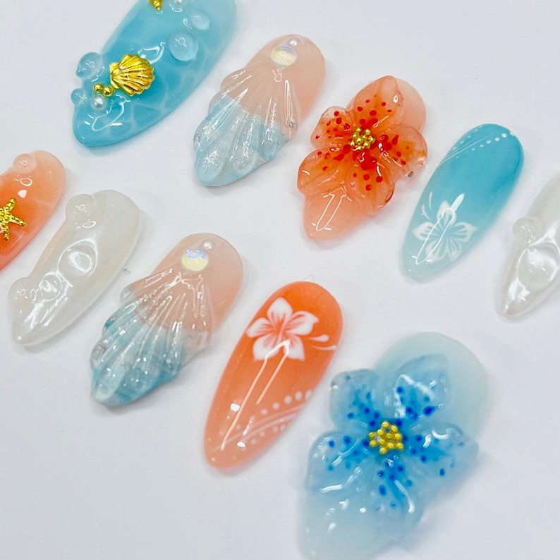 Glossy vacation-ready press on nails with 3D jellyfish, seashells, and blue coral peach gradients