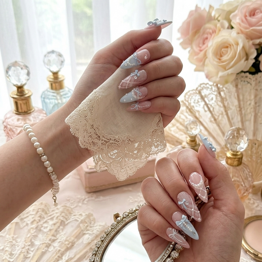 Dreamy pastel blue and pink coquette-style press-on nails featuring 3D bows, pearl accents, and sparkling glitter details by JRNAIL.