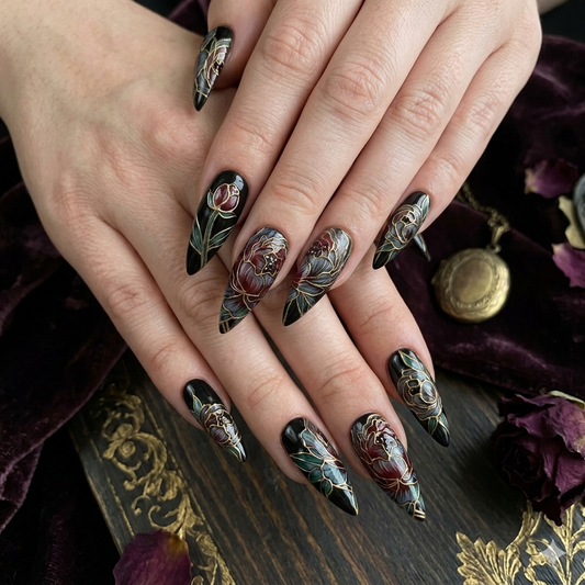 A luxury set of handmade press-on nails featuring dark floral patterns outlined in gold, inspired by gothic stained glass art on professional-grade gel tips.