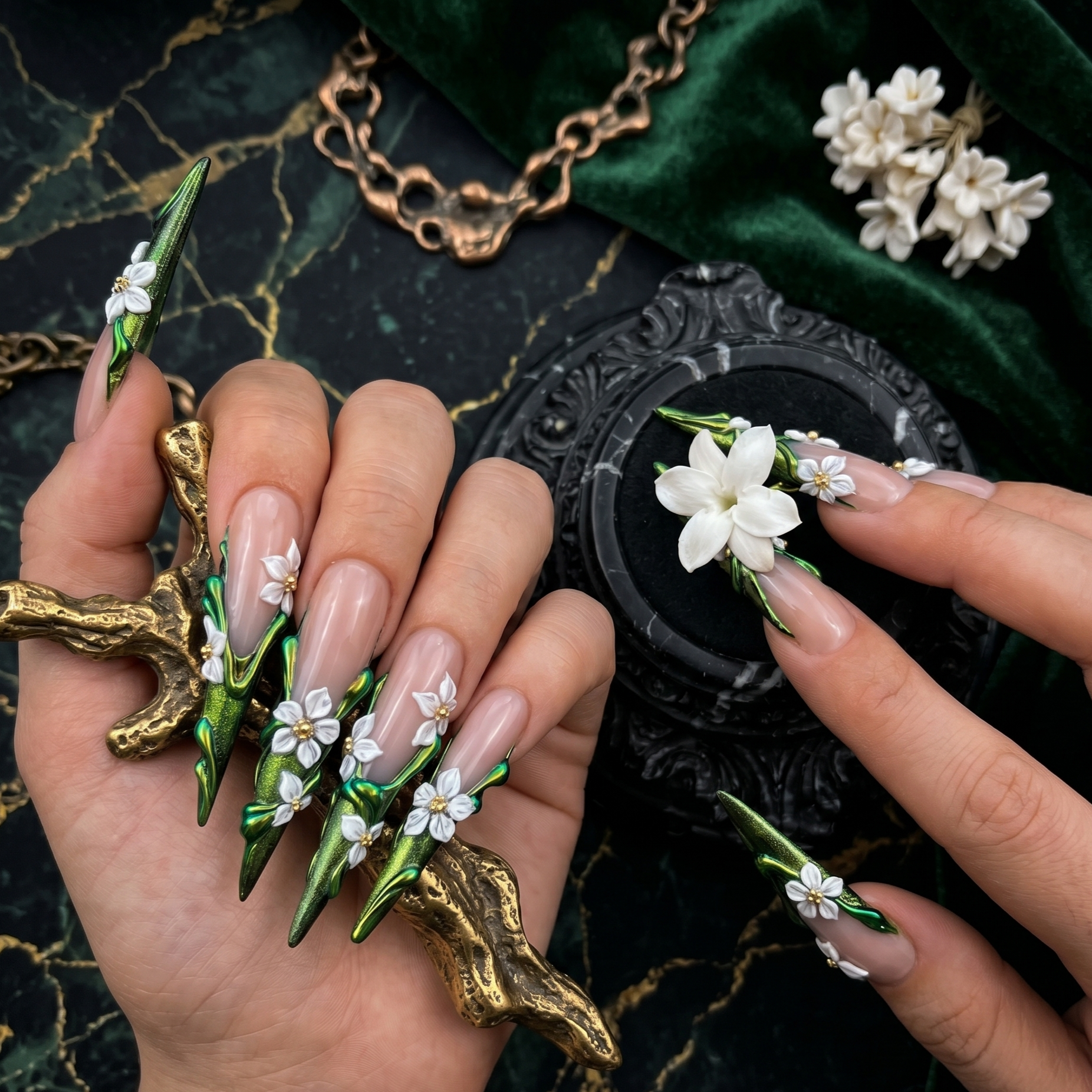 Luxurious hand-sculpted 3D floral press-on nails in deep emerald green chrome with delicate white blossoms and gold accents by JRNAIL.