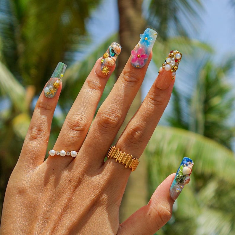 Luxury deep sea false nails with hand-sculpted seahorses, gold accents, and iridescent ombré base