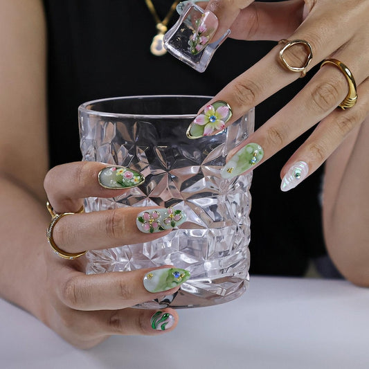 3D fairycore fake nails with dragonfly, cherry blossom, and floral motifs, iridescent marble base, and gold details
