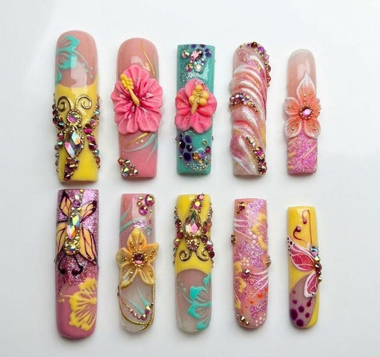 Artistic vacation-ready press-on nails in neon tropical colors with intricate 3D floral art, perfect for a bold island-inspired manicure.