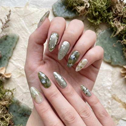 Enchanting almond-shaped press-on nails in moss green with hand-painted butterfly motifs, vine filigree, and 3D dewdrop accents by JRNAIL.