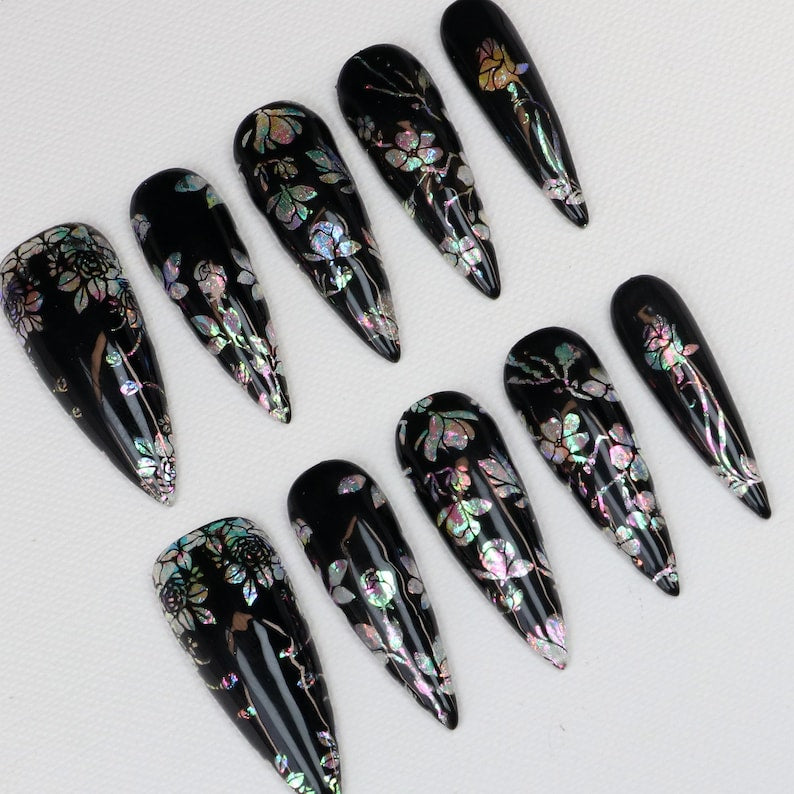 Long black stiletto fake nails with holographic pink silver green floral foil detail