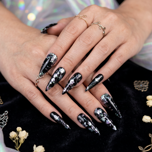 Black holographic press-on nails with iridescent floral design on long stiletto shape