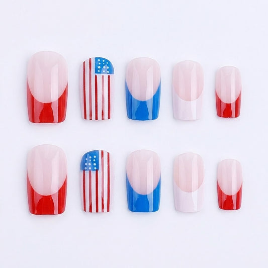 Ten square-shaped press-on nails neatly arranged in two neat rows of five on a crisp, solid white background, displaying a mix of red and blue French tips alongside American flag nail art.