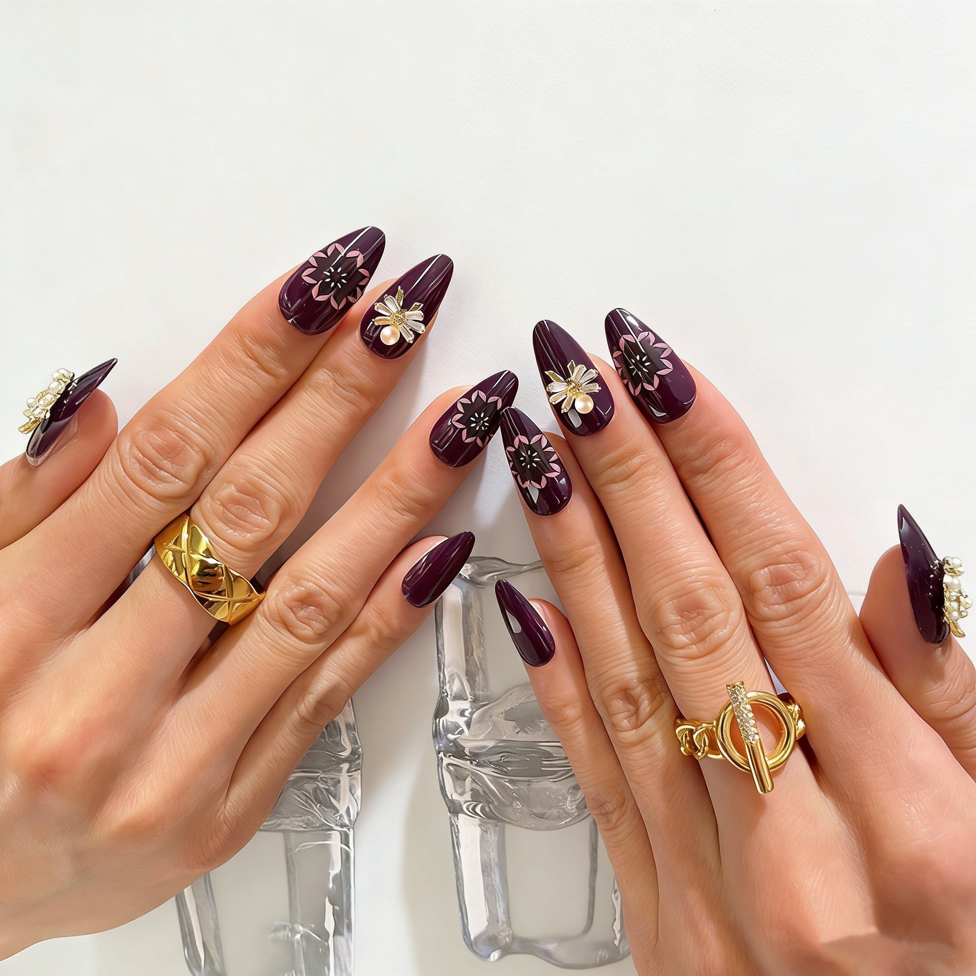 Plum purple almond press on nails with gold moon star charms, pearl accents, and pink floral mandala designs