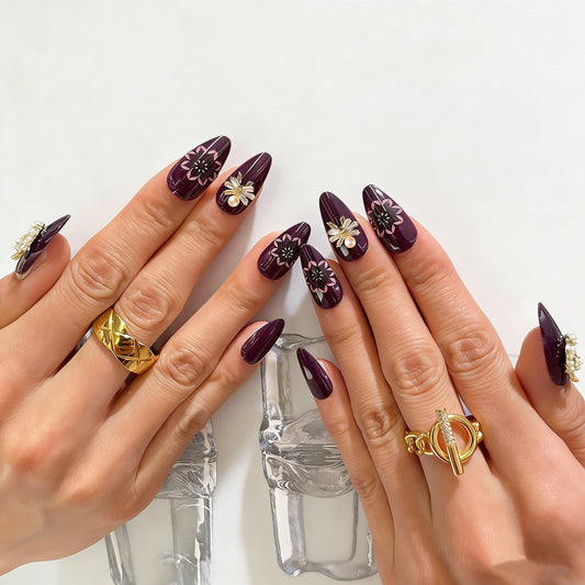 Plum purple almond press on nails with gold moon star charms, pearl accents, and pink floral mandala designs