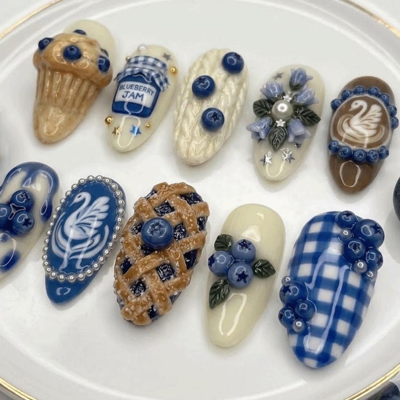High-detail luxury press-on nails with miniature blueberry muffins and food-themed art.