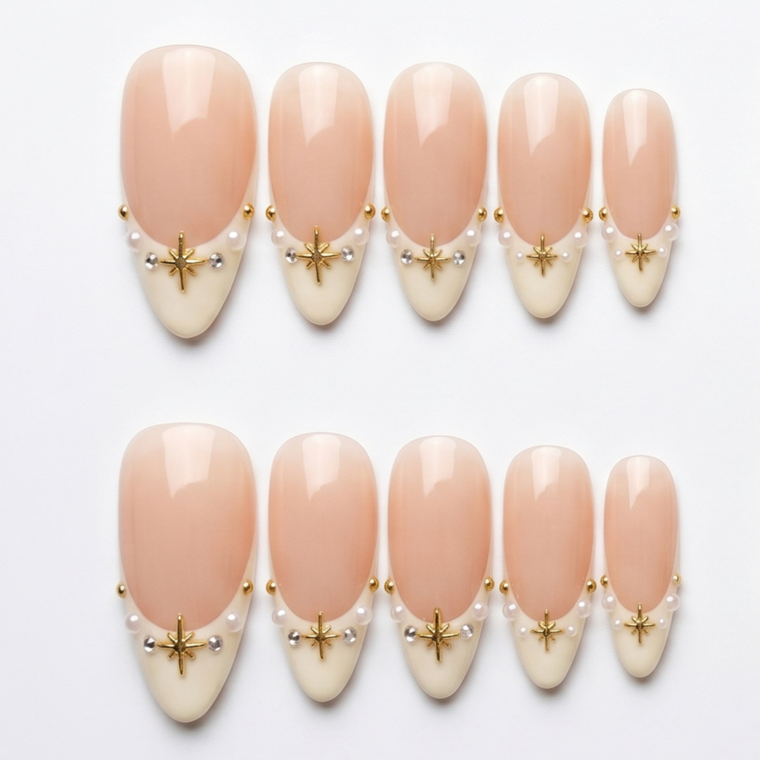 High-quality handmade press-on nails with white French tips, delicate gold stars, and pearls for a sophisticated nail look.