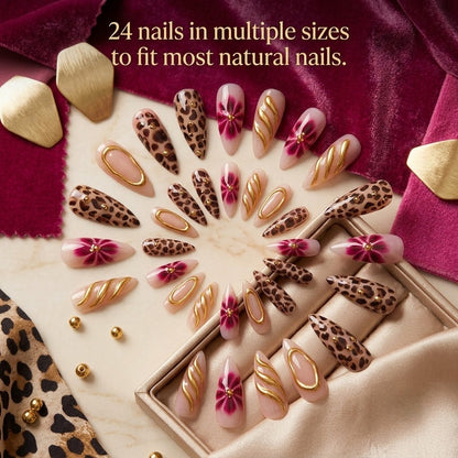 A full 24-piece luxury press-on nail set featuring extra-long stiletto tips with hand-painted leopard print, 3D metallic gold waves, and deep burgundy flower art, organized beautifully in a spiral mosaic pattern on a plush velvet and leopard print background with text reading '24 nails in multiple sizes to fit most natural nails.'