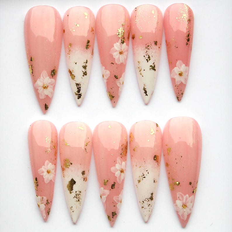 Elegant stiletto-shaped gel press-on nails with delicate hand-painted flowers.