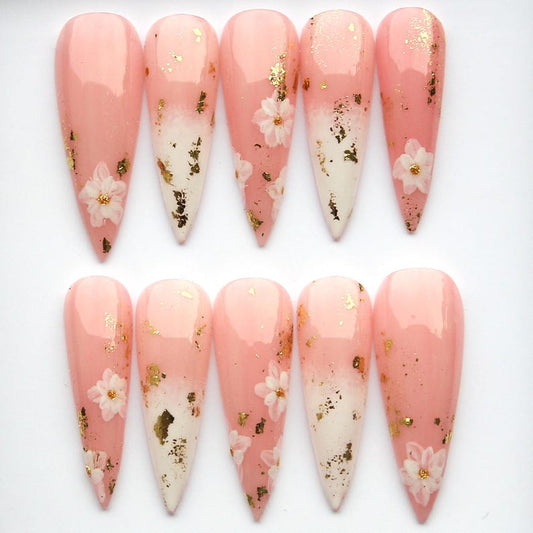 Elegant stiletto-shaped gel press-on nails with delicate hand-painted flowers.