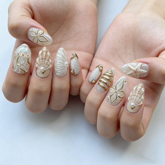 Luxury ocean 3D press on nails with jellyfish starfish, gold foil, and pearl accents, frosty white almond shape