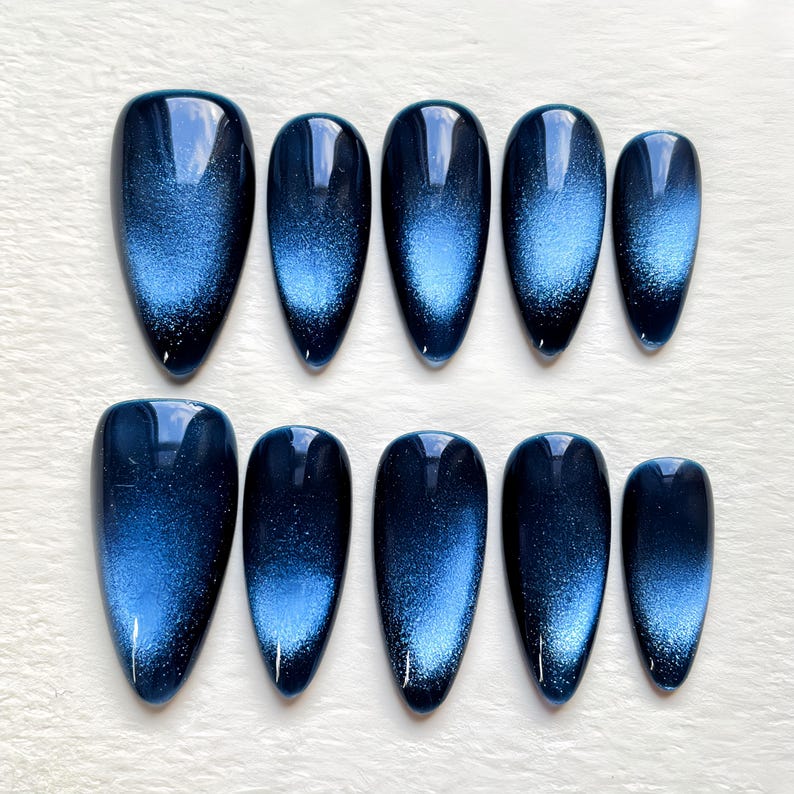 Luxurious navy blue magnetic gel press-on nails with deep 3D light-shifting shimmer, perfect for a modern, celestial-inspired look.