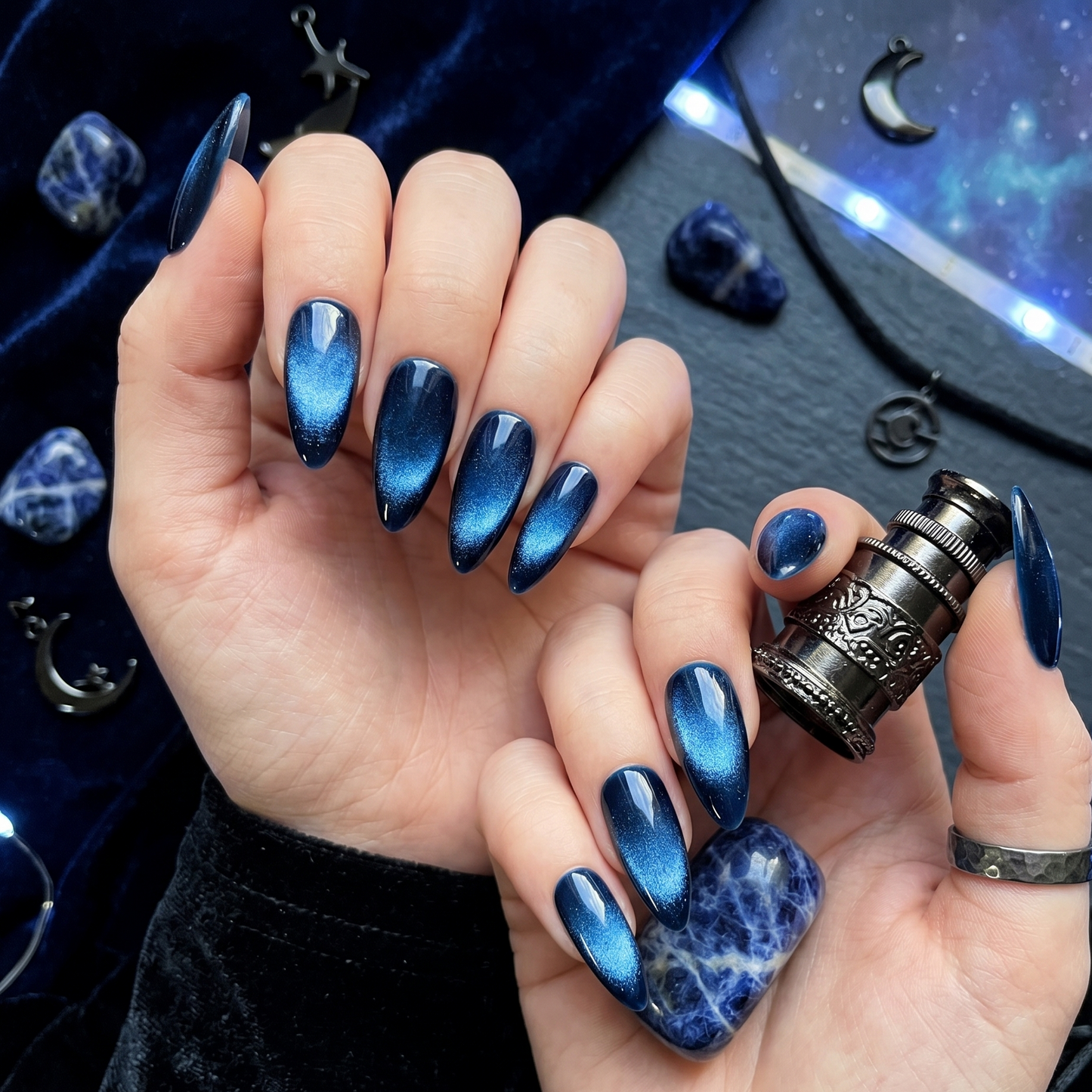Mesmerizing midnight blue cat eye press-on nails featuring a magnetic shimmer galaxy effect and a glossy, salon-quality finish.