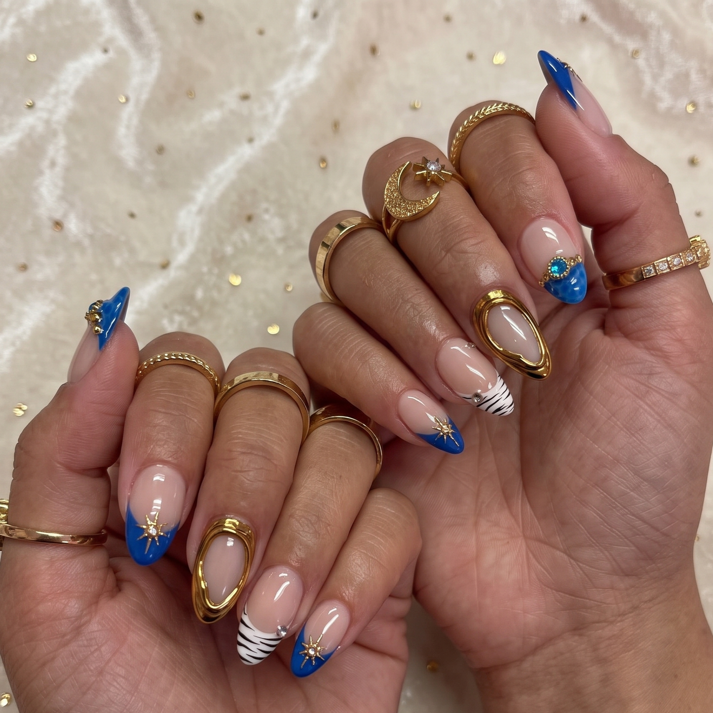 JRNAIL handmade reusable fake nails showcasing multiple sizes in a dramatic royal blue and gold chrome celestial theme, perfect for a custom DIY manicure