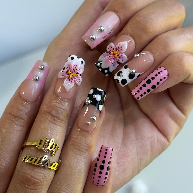 3D lily flower fake nails with black and white polka dots, silver metal studs, and glossy coffin shape