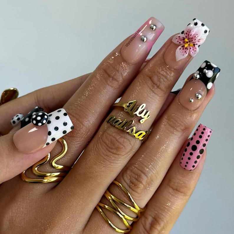 Y2K retro press on nails with 3D lily flower, black white pink polka dots, and silver stud accents