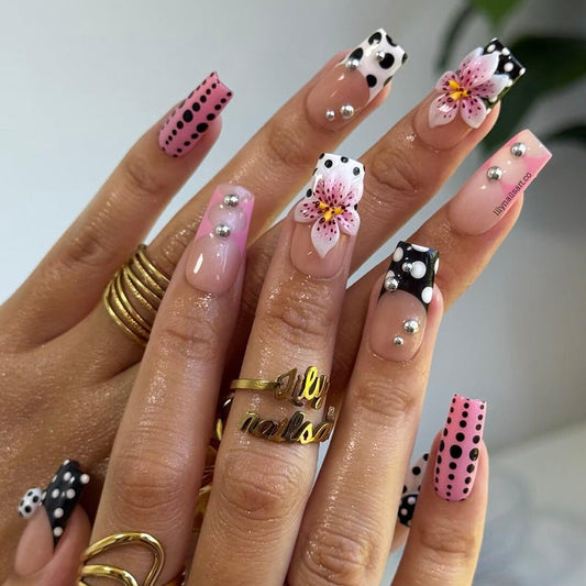 Retro polka dot 3D floral press on nails with silver stud accents, nude base, and black white pink designs