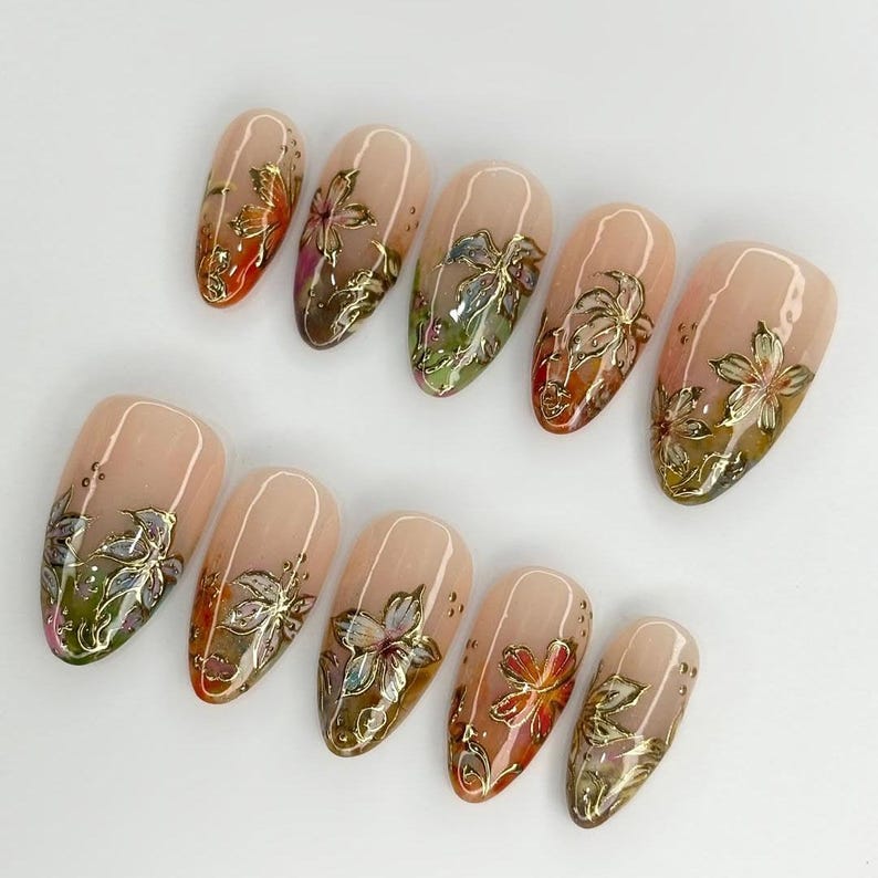 High-quality reusable stiletto fake nails featuring artistic 3D floral designs and gold accents