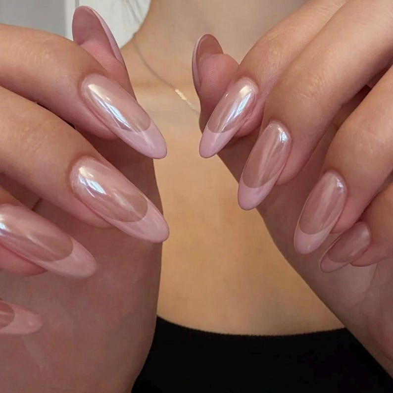 A professional collection of reusable luxury press-on nails in a chic chrome French design, ready for easy application and a salon-quality result.