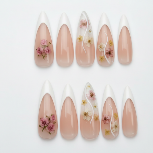 Romantic floral-infused stiletto gel nails, combining a classic French tip with real-style flower art.