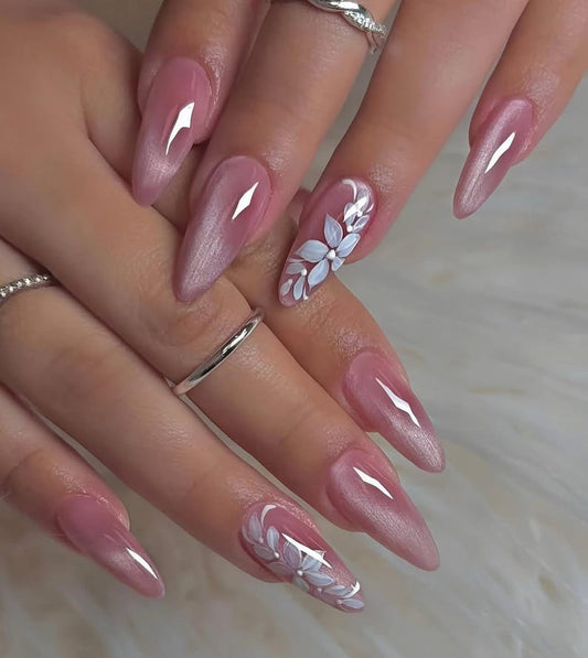 A luxury set of handmade press-on nails featuring a shimmering dusty rose cat-eye gel finish and delicate hand-painted white floral nail art.