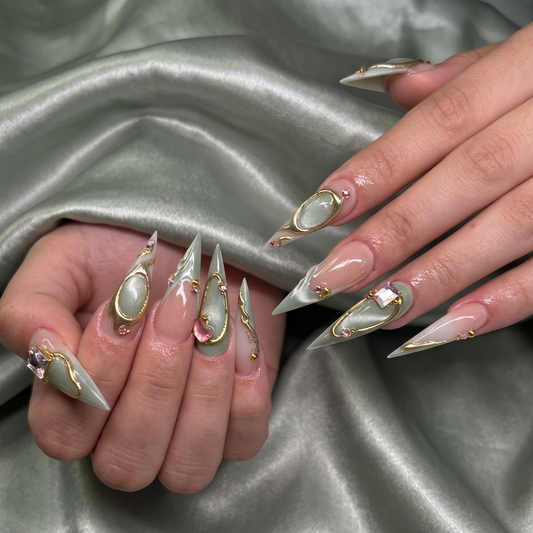 Elegant sage green stiletto press-on nails featuring sophisticated gold wire art and luxury crystal embellishments by JRNAIL.