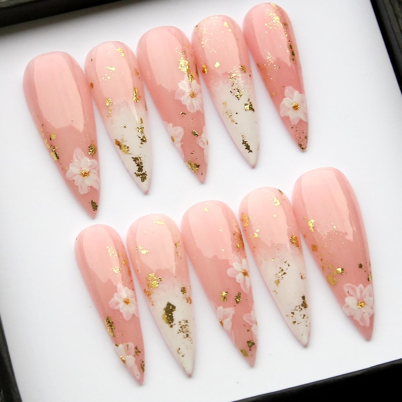Trendy, high-shine gel nail set in soft pink with floral accents for daily wear.