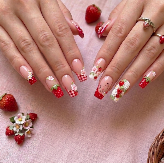 Luxury reusable press-on nails featuring red gingham and strawberry nail art.